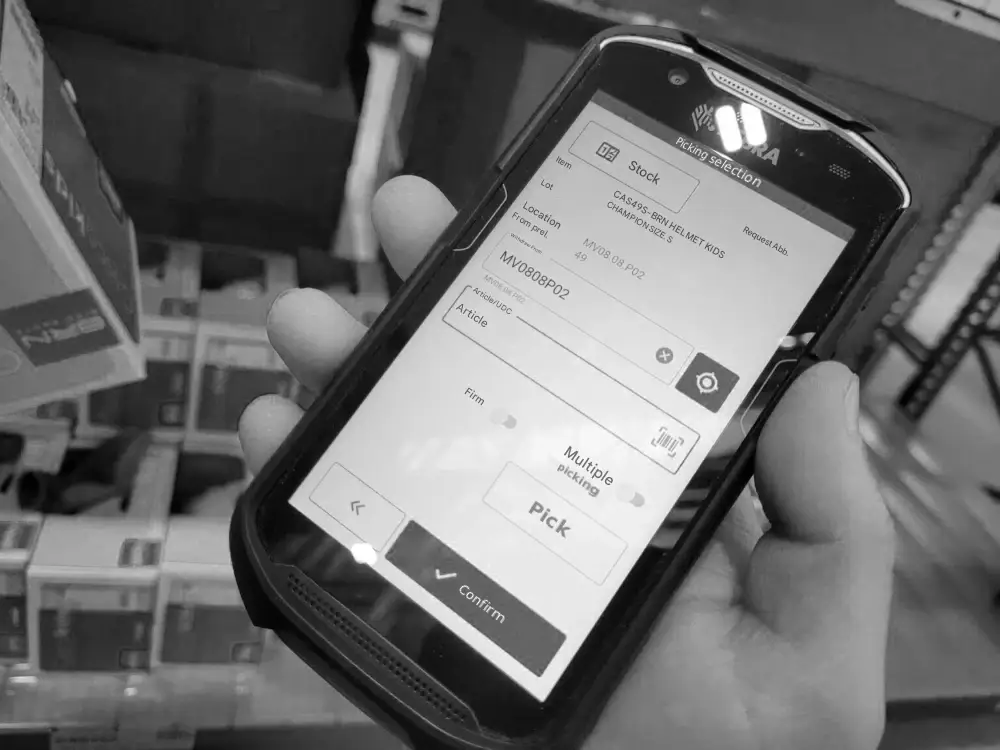 Operator with Zebra mobile device and Stesi silwa WMS software interface for warehouse picking