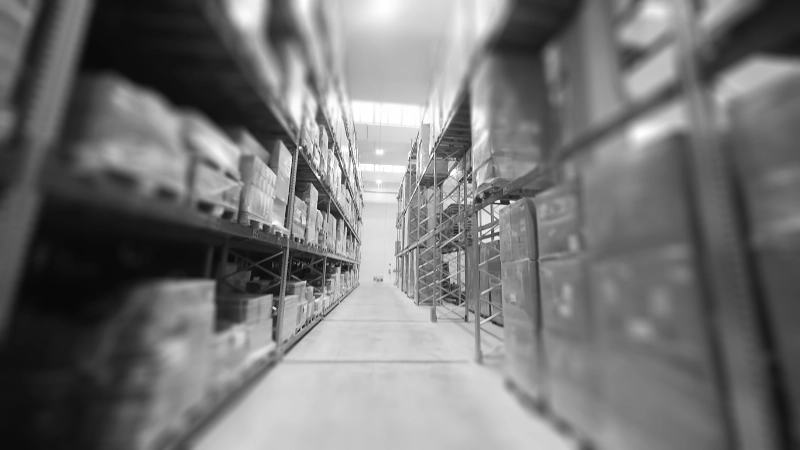 warehouse with stock stored in designated locations and on floor-level shelving