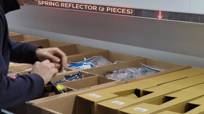 IT and OT integration: an operator retrieves materials following instructions from software