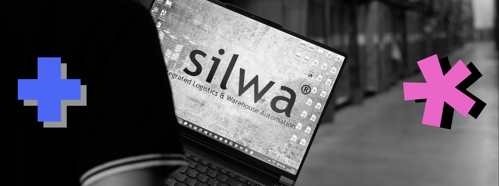 A computer running WMS software held by a developer in a warehouse