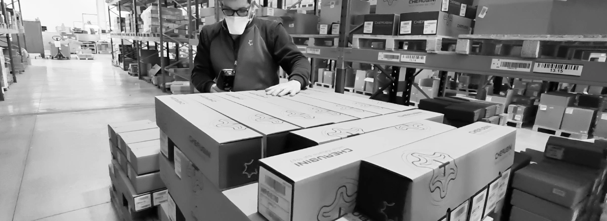 Warehouse operator at Cherubini scanning a barcode using a warehouse management app powered by Stesi's WMS